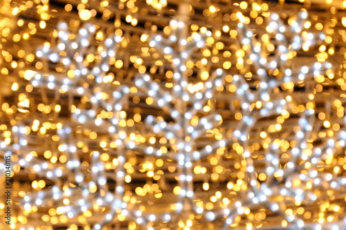 Bokeh background and snow shape gold yellow colorful merry christmas, Happy new year bokeh lighting shine on night background, Bokeh glitter light, Gold Luxury backdrop texture, Glittering wallpaper