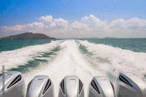 Speed boat engine driving along waving water 