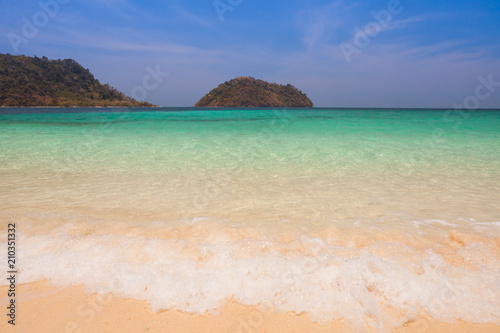 Fototapeta Naklejka Na Ścianę i Meble -  White sand beach with moutain under clear sky at ocean in Tropicana located at south of Thailand 