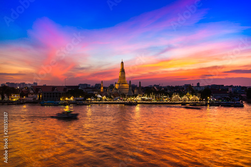 A colorful of sunset time reflection of gold pagoda "Wat Arun" temple of Bangkok at night time 