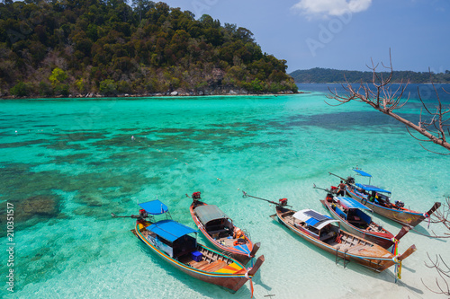 Fototapeta Naklejka Na Ścianę i Meble -  White sand beach beach and long tail boat is floating on sea at ocean in Tropicana located at south of thailand 