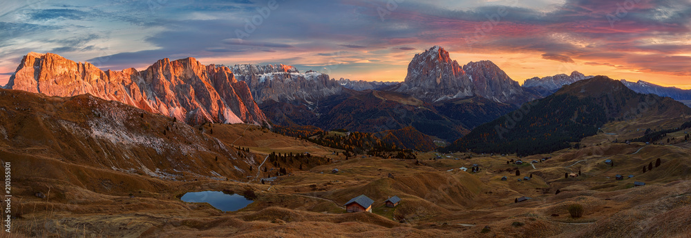 Selva di Val Gardena, Scenic mountain landscape, Italian Dolomites with dramatic sunset and cloudy sky at background.