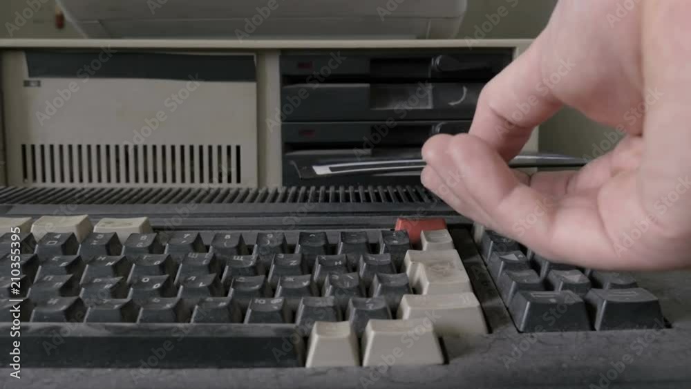 Removing 5.25 Inch floppy disk from old retro personal computer
