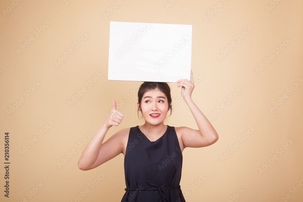 Young Asian woman show thumbs up with white blank sign. Young Asian woman show thumbs up with white blank sign.