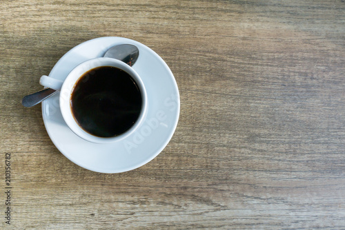 A cups of coffee on orange color wooden table background