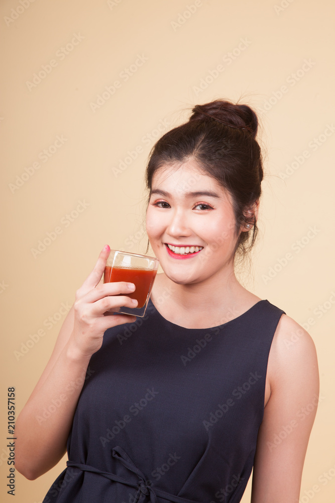 Young Asian woman thumbs up with tomato juice. Young Asian woman thumbs up with tomato juice.