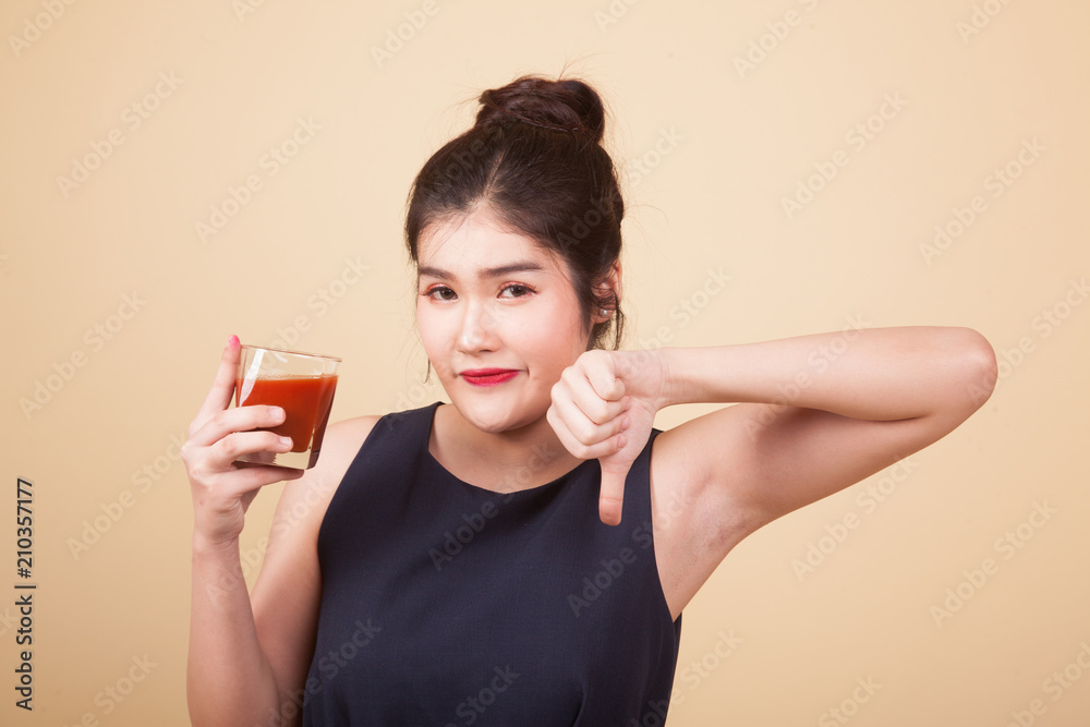 Young Asian woman hate tomato juice. Young Asian woman hate tomato juice.