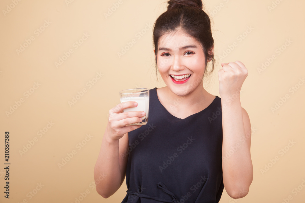 Healthy Asian woman drinking a glass of milk. Healthy Asian woman drinking a glass of milk.
