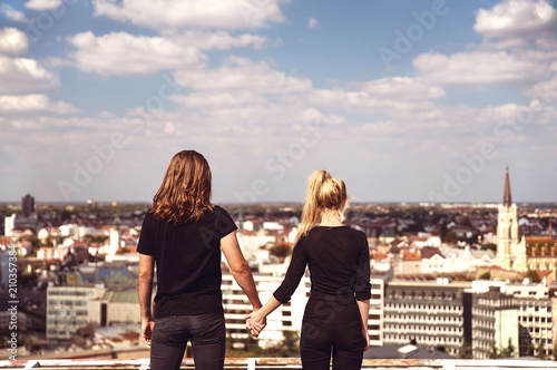 Fototapeta Naklejka Na Ścianę i Meble -  Young couple on rooftop