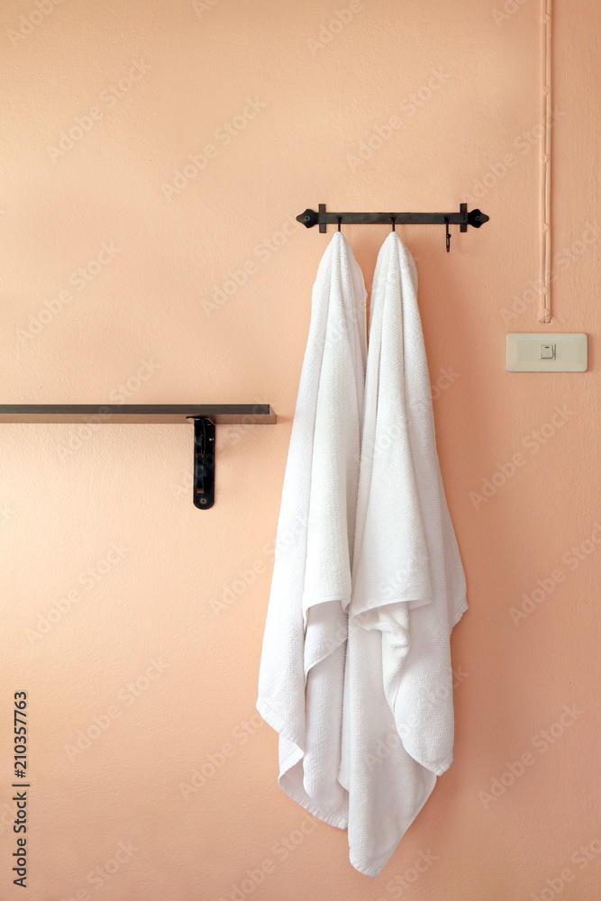 Fototapeta premium towel, a towel hangs on an orange wall (selective focus)