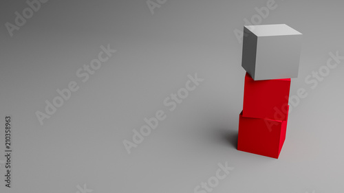 Two red boxes and one white cube stacked in front of a grey background