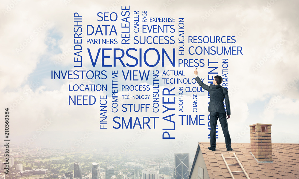 Young businessman standing on house roof and writing leadership Young businessman standing on house roof and writing leadership