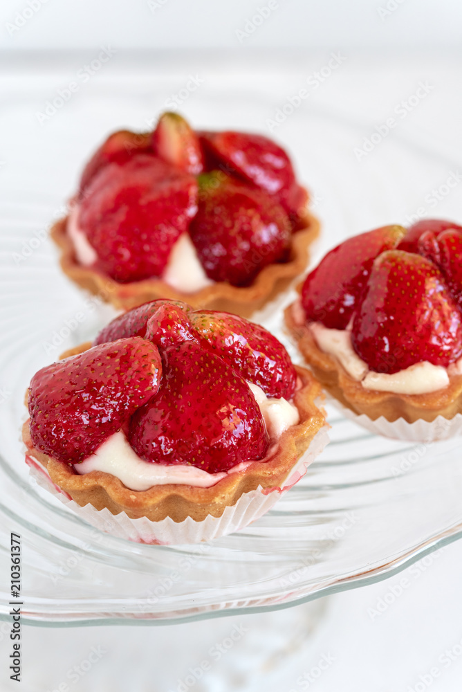 Tartlets with strawberries and cream. Dessert with fresh fruits. Tartlets with strawberries and cream. Dessert with fresh fruits.