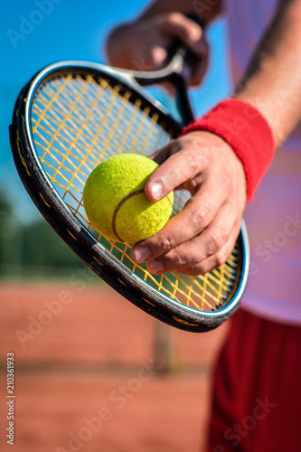 Player's hand with tennis ball preparing to serve © nikolaborovic88