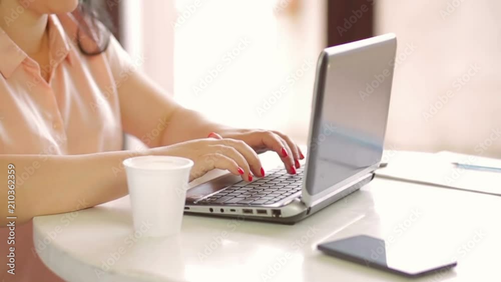 Hands of a young woman working on a laptop. slow mo. close-up. Hands of a young woman working on a laptop. slow mo. close-up.