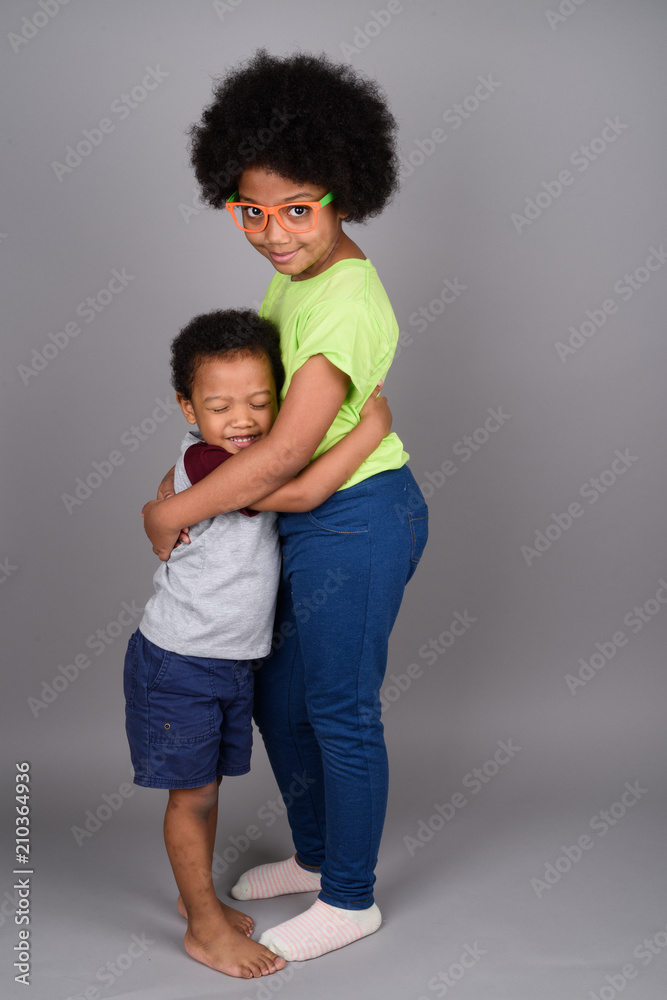 Young cute African brother and sister hugging Young cute African brother and sister hugging