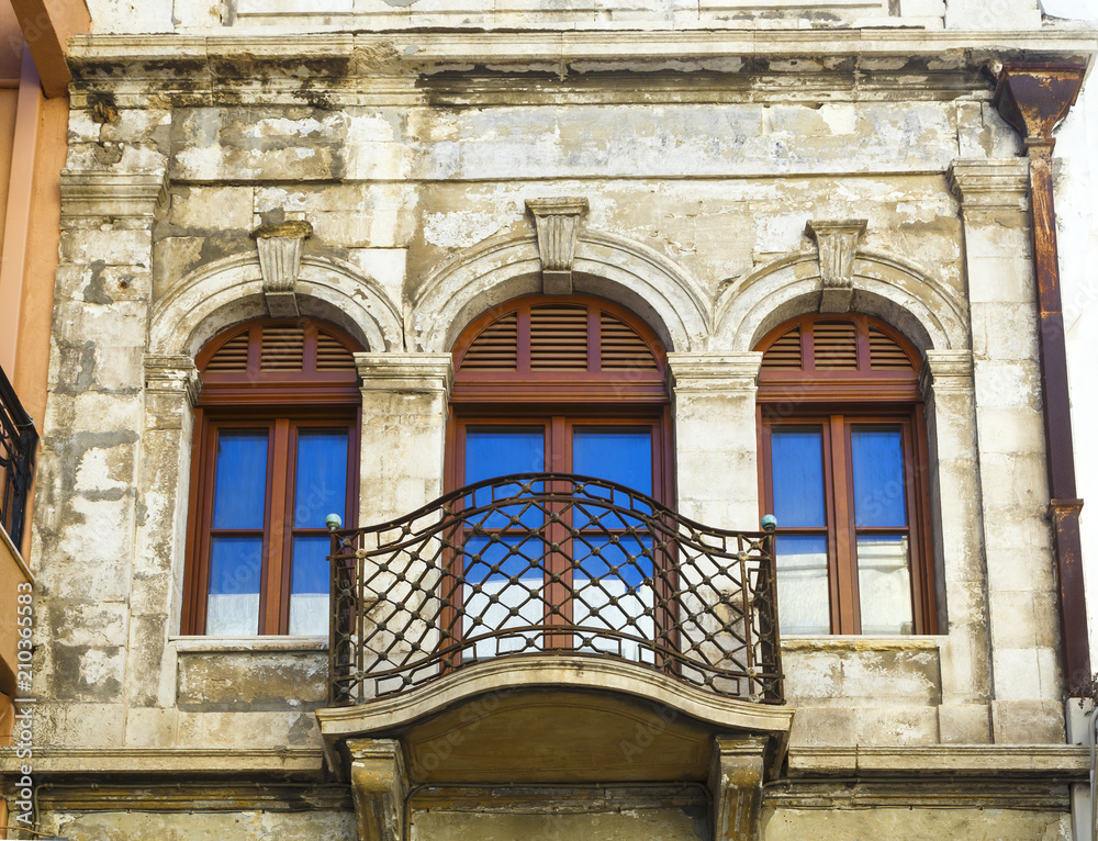 Obraz premium Facade of traditional colorful european italian apartment building in heraklion downtown urban old city street, Greece, Europe