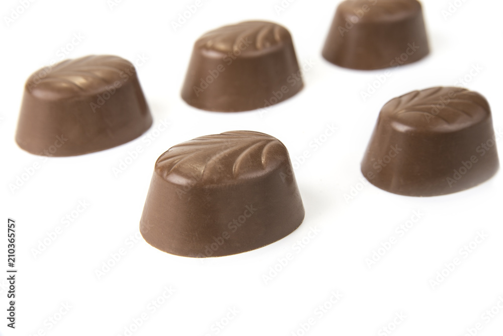 Delicious chocolate pralines on the white. Sweet candy Delicious chocolate pralines on the white. Sweet candy