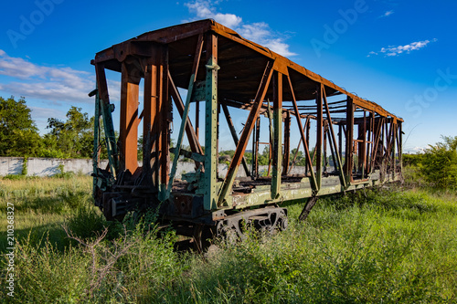 Forgotten overgrown railway. Old rusty ruined freight carriage © Mulderphoto