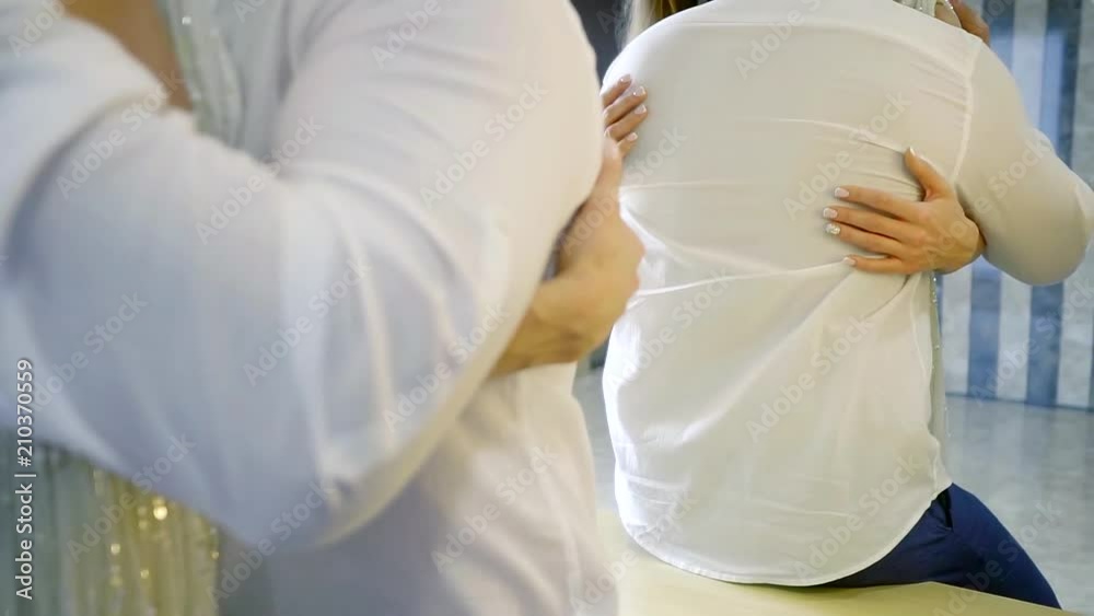 the lady embraces her husband's waist, she is happy and glad to be close to him