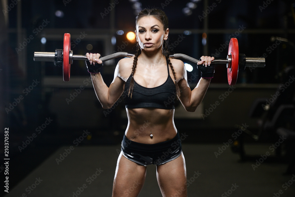brunette sexy athletic young girl working out in gym brunette sexy athletic young girl working out in gym
