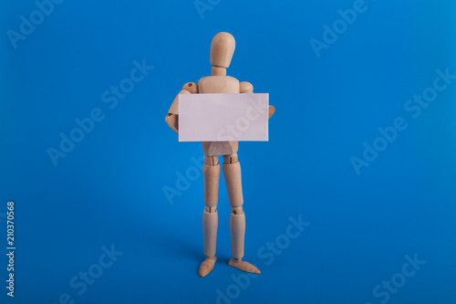 Wooden manikin holding blank white sign just add text