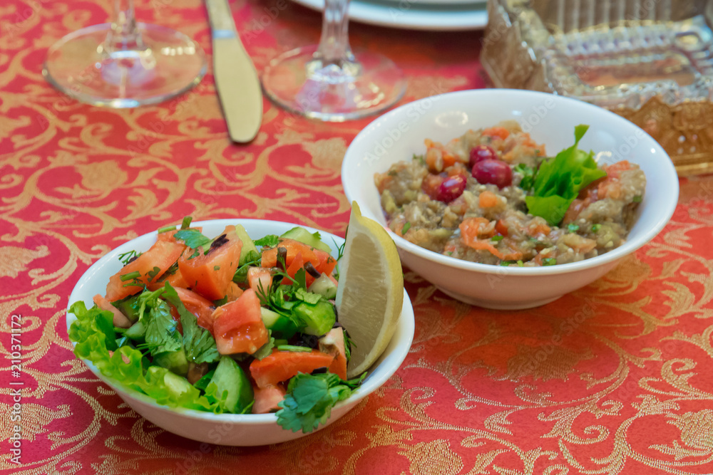 Salad of cucumbers, tomatoes and red onion is in the plate . Tomato,cucumber and onion salad . Salad of cucumbers, tomatoes and red onion is in the plate . Tomato,cucumber and onion salad .
