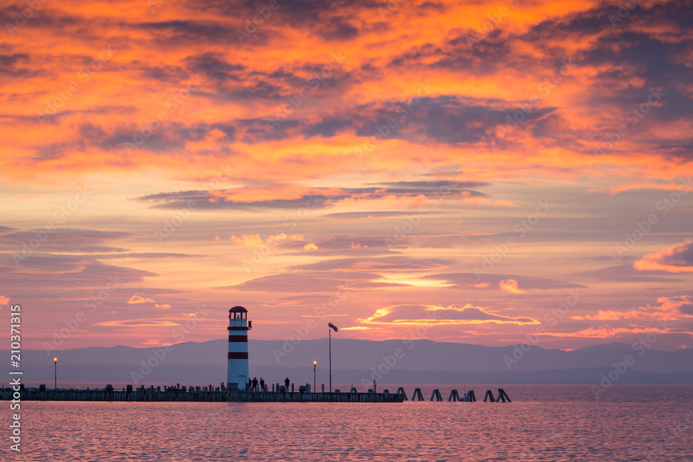 Obraz premium Lighthouse in Podersdorf am See at winter sunset, lake Neusiedler See, Burgenland, Austria