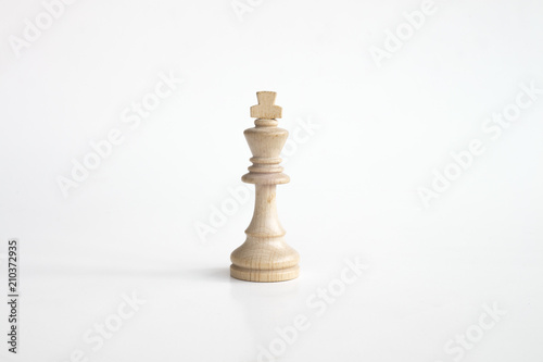 White king chess piece in white isolated background photo