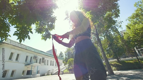 Portrait of young woman - box spotsman in summer park during work out training photo