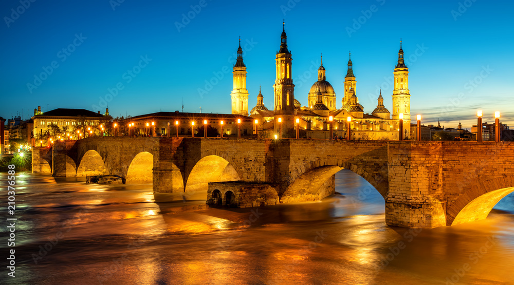 Zaragoza city, Spain, bridge and Cathedral del Pilar at sunset