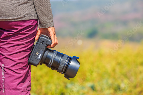 Photographer holds her DSLR camera