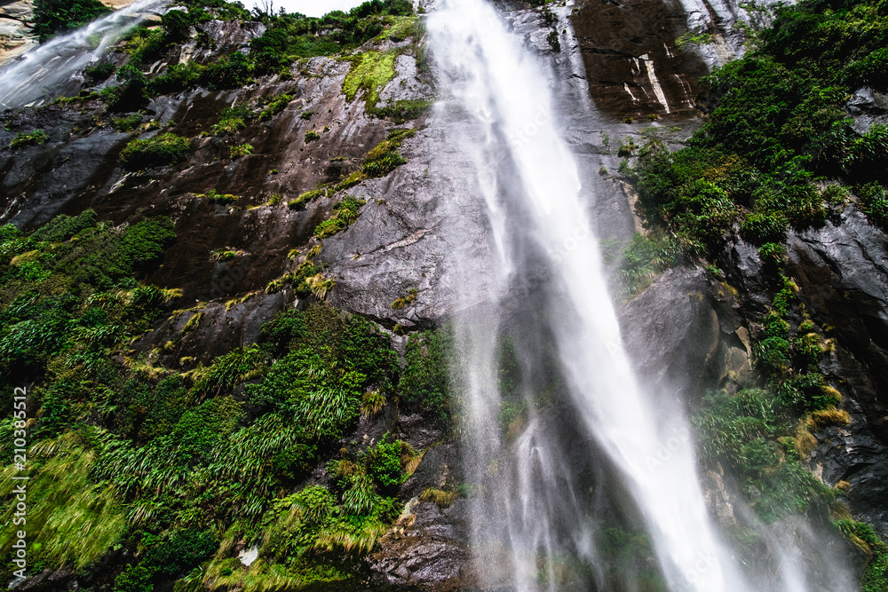 A stunning scene under waterfalls while cruising at Milford Sound, New Zealand.