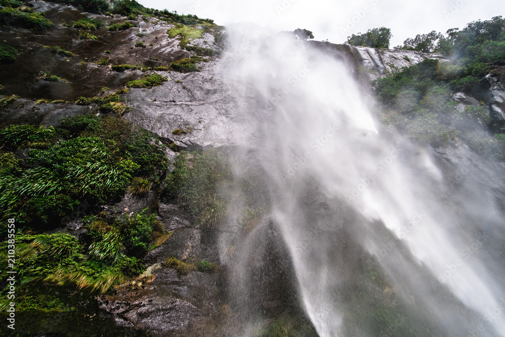 A stunning scene under waterfalls while cruising at Milford Sound, New Zealand.