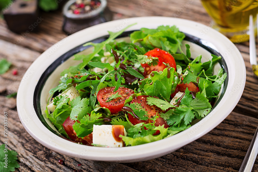 Salad with tomatoes, cheese and cilantro in sweet and sour sauce. Georgian cuisine. Healthy food. Salad with tomatoes, cheese and cilantro in sweet and sour sauce. Georgian cuisine. Healthy food.