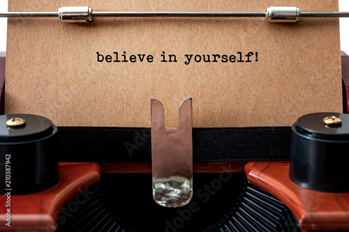 Self determination and motivational quote concept with close up on the print text believe in yourself in a vintage typewriter