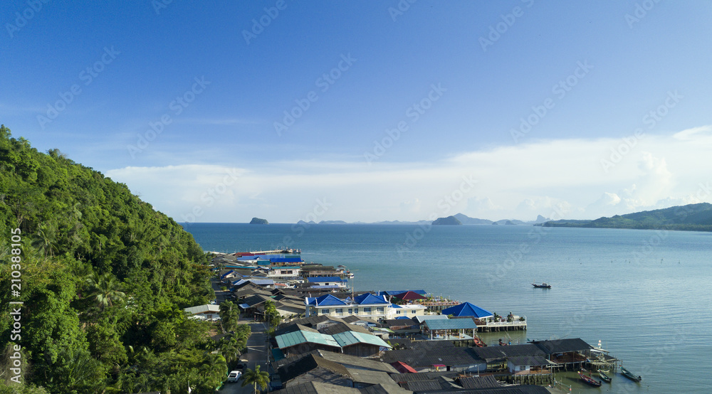 Top view aerial photo from flying drone of fishing village, chumporn, thailand, Southeast Asia. with sea landscape and amazing blue water.