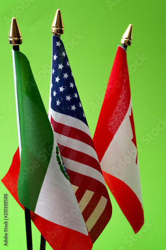 North American Free Trade Agreement or Nafta and 2026 football world cup organizing countries concept with close up on the flags of Mexico, USA and Canada