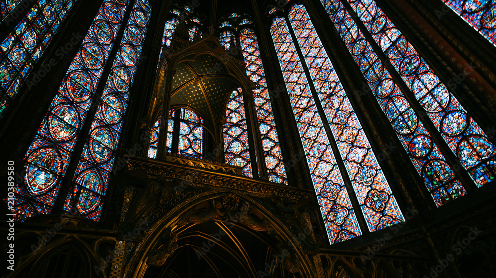 Stained glass walls and ceiling at Saint Chapelle, a public building in Paris, France