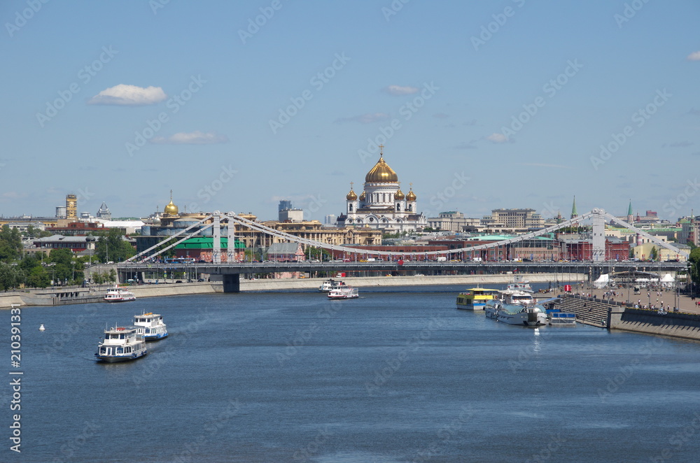 Moscow, Russia - June 15, 2018: Crimean bridge, Cathedral of Christ the Saviour and the Moscow river with pleasure boats on a Sunny summer days