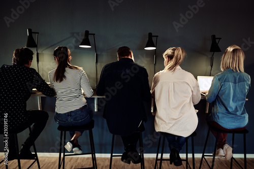 Group of businesspeople working late in an office together