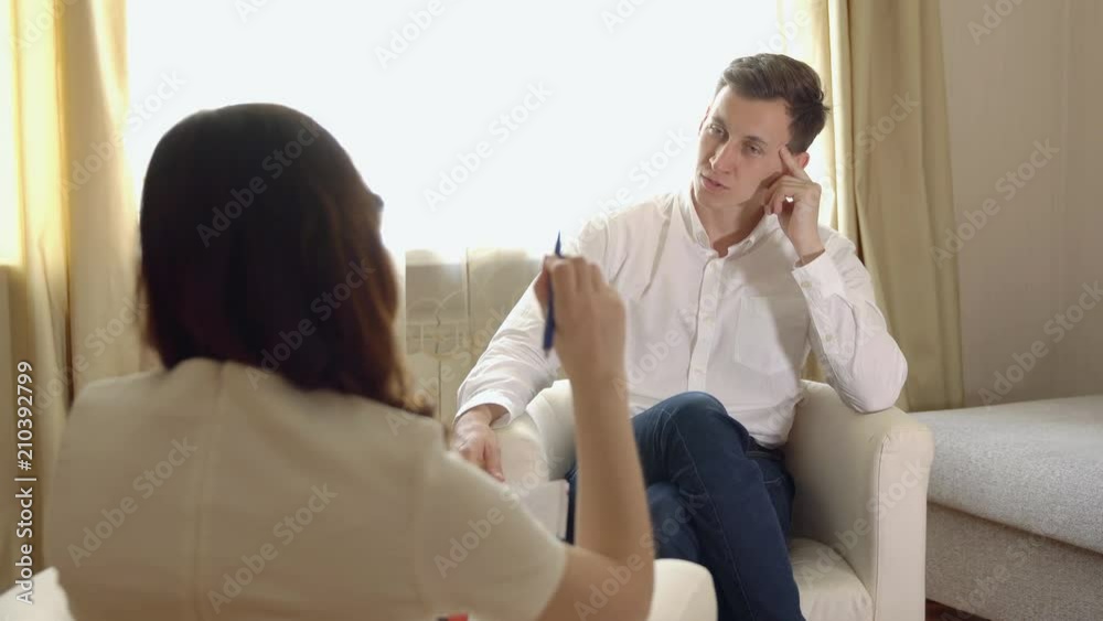 Young man at the reception of a woman psychologist. Young man at the reception of a woman psychologist.