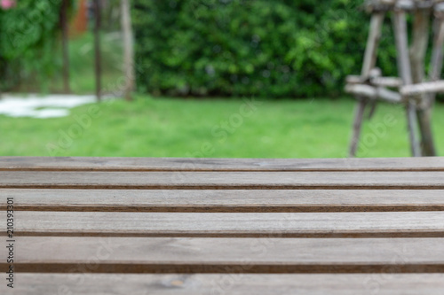Empty wooden table with garden background. © 9Air