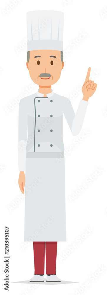 An elderly male chef wearing a cook coat is pointing
