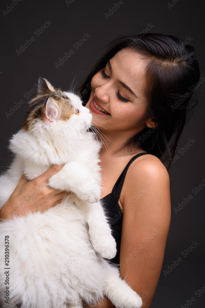 Young beautiful Asian woman holding Persian cat Young beautiful Asian woman holding Persian cat