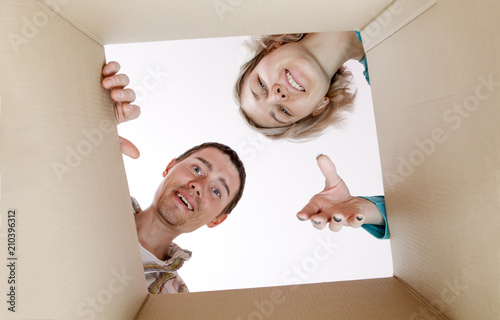 Picture of man and woman peering into cardboard box