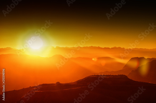 sunset in the mountains, backlight, the sun hides behind the mountains, an observation deck, the rays of the sun, the end of the day