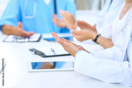 Group of doctors applauding at medical meeting. Close up of physician hands. Teamwork in medicine 