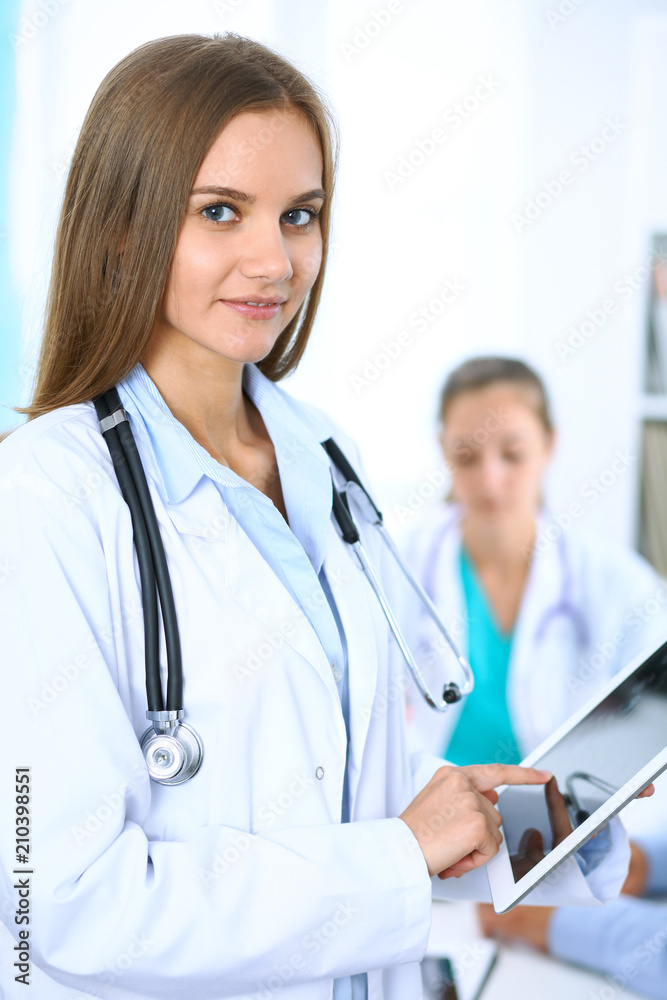 Doctor using tablet computer, close-up of hands at touch pad screen Doctor using tablet computer, close-up of hands at touch pad screen