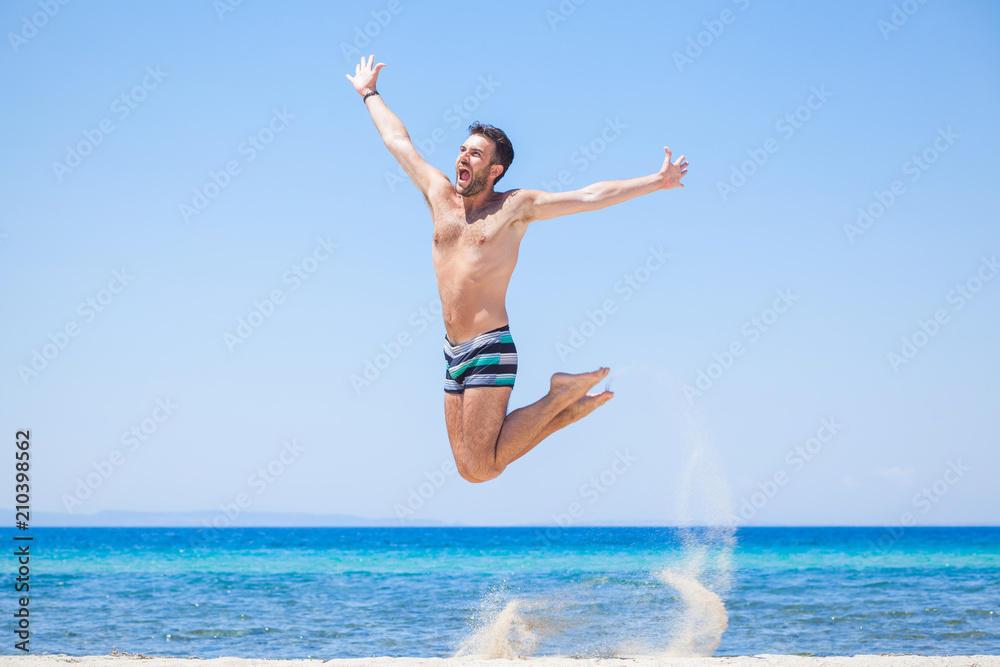 Happy traveler jumping happy at the beach, summer holiday Happy traveler jumping happy at the beach, summer holiday